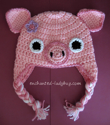 crocheted pink pig hat with earflaps and tassels
